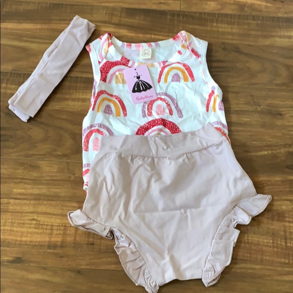 Rainbow onesies with bloomers and matching bow.